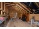 Unfinished attic space with exposed wooden beams, offering potential for storage or customization at 13217 Oak Farm Ln, Huntersville, NC 28078