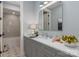 Serene bathroom boasts a marble countertop, shaker cabinets, modern fixtures, and an attached shower-tub combination at 13217 Oak Farm Ln, Huntersville, NC 28078
