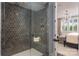 Stylish shower with dark gray hexagon tile, a glass door, and a built-in shelf at 13217 Oak Farm Ln, Huntersville, NC 28078