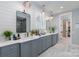 Bathroom with dual sinks, plenty of cabinet space, stylish light fixtures, and a glass shower enclosure at 13217 Oak Farm Ln, Huntersville, NC 28078