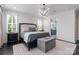 Bright bedroom featuring shiplap accent wall and a glimpse into the en suite bathroom at 13217 Oak Farm Ln, Huntersville, NC 28078