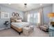 Inviting bedroom with a plush bed, light blue walls, and two storage ottomans offers a relaxing retreat at 13217 Oak Farm Ln, Huntersville, NC 28078