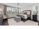 Bedroom with lots of natural light, decorative accent wall, and a rustic storage chest at 13217 Oak Farm Ln, Huntersville, NC 28078