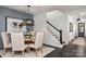 Dining room with table and chairs near staircase and featuring an interesting chandelier and artwork at 13217 Oak Farm Ln, Huntersville, NC 28078