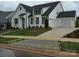 Charming two-story home with white siding, black trim, well-manicured lawn, and a driveway at 13217 Oak Farm Ln, Huntersville, NC 28078