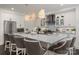 Bright, spacious kitchen featuring an island with barstool seating, stylish pendant lights, and stainless appliances at 13217 Oak Farm Ln, Huntersville, NC 28078