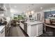 Modern kitchen featuring a large island with pendant lighting and stainless steel appliances that opens to the living room at 13217 Oak Farm Ln, Huntersville, NC 28078