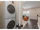 Convenient laundry area with stacked white Electrolux washer and dryer units at 13217 Oak Farm Ln, Huntersville, NC 28078