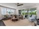 Cozy living room with a plush sofa, large windows, and sliding glass doors to the patio at 13217 Oak Farm Ln, Huntersville, NC 28078