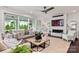 Comfortable living room with a fireplace, stylish seating, and sliding glass doors to the outdoor area at 13217 Oak Farm Ln, Huntersville, NC 28078