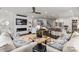 Open-concept living room with a fireplace, comfortable sofas, and seamless flow to the kitchen at 13217 Oak Farm Ln, Huntersville, NC 28078