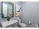 Well-lit powder room featuring stylish vanity and an attractive mirror and artwork at 13217 Oak Farm Ln, Huntersville, NC 28078