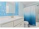Updated bathroom features blue tile backsplash and white vanity with shower and toilet at 1347 Eisenhower Nw Pl, Concord, NC 28027