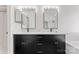 Bathroom featuring dual sinks, quartz countertops, black fixtures, and modern lighting at 1347 Eisenhower Nw Pl, Concord, NC 28027
