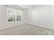 Bright, carpeted bedroom features large window providing ample natural light to the space at 1347 Eisenhower Nw Pl, Concord, NC 28027