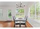 Bright dining area with a modern light fixture, table, and a view to the outdoors at 1347 Eisenhower Nw Pl, Concord, NC 28027