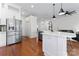 Spacious kitchen featuring stainless steel appliances, a large island with pendant lighting, and hardwood floors at 1347 Eisenhower Nw Pl, Concord, NC 28027