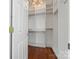 Spacious walk-in closet with custom shelving and a stylish chandelier at 1347 Eisenhower Nw Pl, Concord, NC 28027
