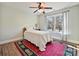 Bedroom with wood floors, rug, ceiling fan, and large window with natural light at 1525 Autumn Brook Ln # 78, York, SC 29745