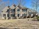 Traditional brick home featuring a manicured lawn and mature landscaping with a three car garage at 1525 Autumn Brook Ln # 78, Clover, SC 29745