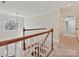 Upstairs hallway with wood railing and trim, and natural light from a window at 1525 Autumn Brook Ln # 78, York, SC 29745