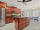 A spacious kitchen features stainless steel appliances, wood cabinets, and a large kitchen island with granite countertops at 1525 Autumn Brook Ln # 78, York, SC 29745