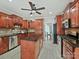 A bright kitchen features wooden cabinets, stainless steel appliances, granite countertops, and a spacious island at 1525 Autumn Brook Ln # 78, York, SC 29745