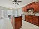 The kitchen features wooden cabinets, stainless steel appliances, granite countertops, tile backsplash, and an island at 1525 Autumn Brook Ln # 78, York, SC 29745