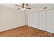 This bedroom features hardwood floors, a ceiling fan, and double closets for ample storage at 1606 Eagles Pl # J101, Rock Hill, SC 29732