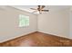 Bedroom featuring neutral walls, wood floors, ceiling fan, and natural light from the window at 1606 Eagles Pl # J101, Rock Hill, SC 29732