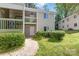 Exterior view of a two-story home with balcony, complemented by lush landscaping at 1606 Eagles Pl # J101, Rock Hill, SC 29732