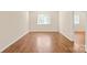 Bright living room featuring hardwood floors, neutral walls, a large window, and ample natural light at 1606 Eagles Pl # J101, Rock Hill, SC 29732