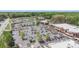 An aerial view showing the shopping center, adjacent businesses, and the surrounding wooded area at 16308 Poplar Tent Rd, Huntersville, NC 28078