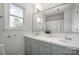 Bathroom featuring a double sink, large mirror, and bright lighting at 16308 Poplar Tent Rd, Huntersville, NC 28078