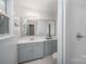 Bright and modern bathroom with a large vanity mirror and walk-in shower at 16308 Poplar Tent Rd, Huntersville, NC 28078