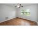 This bedroom features hardwood floors, a ceiling fan, and a window offering natural light at 16308 Poplar Tent Rd, Huntersville, NC 28078