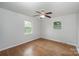 Bedroom featuring hardwood floors, bright windows, and a ceiling fan at 16308 Poplar Tent Rd, Huntersville, NC 28078