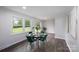 Cozy dining area with a modern table, lush green chairs, and views of the large backyard at 16308 Poplar Tent Rd, Huntersville, NC 28078