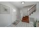 Foyer with tile flooring, stairs and a modern front door, creating an inviting entry to the home at 16308 Poplar Tent Rd, Huntersville, NC 28078