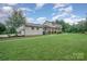 Beautiful home featuring neutral siding, an expansive lawn, and mature trees at 16308 Poplar Tent Rd, Huntersville, NC 28078