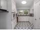 Charming kitchen featuring white cabinets, granite countertops, and a striking black and white tile floor at 16308 Poplar Tent Rd, Huntersville, NC 28078