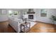 Bright living room with hardwood floors, a cozy fireplace, and ample natural light at 16308 Poplar Tent Rd, Huntersville, NC 28078
