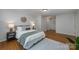 This bright main bedroom features hardwood floors and stylishly decorated nightstands at 16308 Poplar Tent Rd, Huntersville, NC 28078