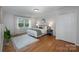 This main bedroom features wood floors, a bright window, and closet for ample storage at 16308 Poplar Tent Rd, Huntersville, NC 28078