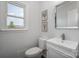 Bright powder room features a sleek, floating vanity, modern faucet, and lovely framed prints at 16308 Poplar Tent Rd, Huntersville, NC 28078