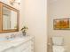 Well-lit bathroom featuring a sleek vanity and a classic toilet offering a comfortable and functional space at 17109 Cabarrus Rd, Midland, NC 28107
