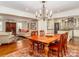 Elegant dining area with hardwood floors, chandelier, and seamless flow to the living room and kitchen at 17109 Cabarrus Rd, Midland, NC 28107