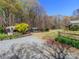 Gravel driveway leading to home with mature trees, greenery, and shed at 17109 Cabarrus Rd, Midland, NC 28107