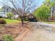 Gravel driveway leads to a brick home with a two-car garage and beautifully landscaped surroundings at 17109 Cabarrus Rd, Midland, NC 28107