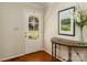 Entryway featuring hardwood floors, glass paneled door, console table, and elegant decor at 17109 Cabarrus Rd, Midland, NC 28107